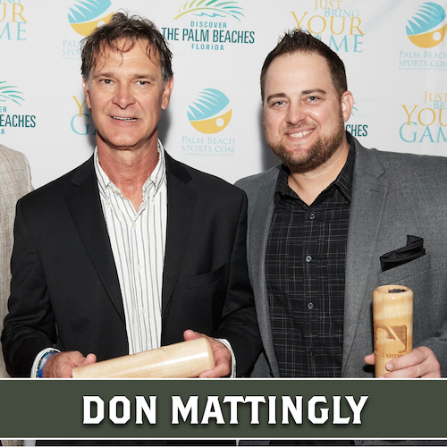 Don Mattingly holding a wooden Dugout Mugs baseball bat mug horizontally beside another man holding a mug upright.